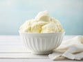 Bowl with tasty vanilla ice cream on table against light background. Created with Generative AI technology. Royalty Free Stock Photo