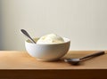 Bowl with tasty vanilla ice cream on table against light background. Created with Generative AI technology. Royalty Free Stock Photo