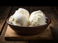 Bowl with tasty vanilla ice cream on table against light background. Created with Generative AI technology. Royalty Free Stock Photo