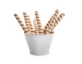 Bowl with tasty wafer roll sticks on white background. Royalty Free Stock Photo