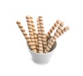 Bowl with tasty wafer roll sticks on white background. Royalty Free Stock Photo