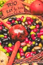 Bowl of three types of ripe, raw, local olives in olive oil and a wood handled scoop