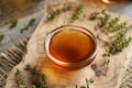 A bowl of thyme syrup on a table Royalty Free Stock Photo
