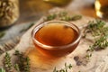 A bowl of thyme syrup on a wooden table Royalty Free Stock Photo