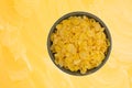 Bowl of toasted corn cereal on a yellow background Royalty Free Stock Photo