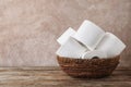 Bowl with toilet paper rolls on wooden table Royalty Free Stock Photo