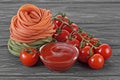 Bowl of tomato sauce, cherry tomatoes and italian pasta on wooden background Royalty Free Stock Photo