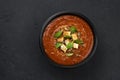 Bowl of tomato soup on black background, top view Royalty Free Stock Photo