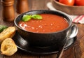 Bowl of tomato soup garnished with basil leaves Royalty Free Stock Photo