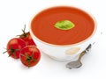 Bowl with tomato soup gazpacho, tomatoes, basil leaf and spoon. Isolated on white background. Mediterranean diet food composed of Royalty Free Stock Photo