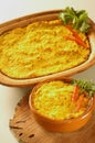 Bowl of traditional Chilean Pastel de Choclo (corn pie) photographed with natural light. Below the corn-basil Royalty Free Stock Photo