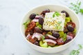 Bowl of traditional Greek salad with tomatoes, cucumbers, red onions, kalamata olives, feta sheep cheese and olive oil Royalty Free Stock Photo