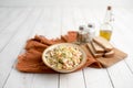 Bowl of traditional Russian salad called Olivie, Russian New Year or Christmas salad on wooden background. Royalty Free Stock Photo