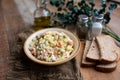 Bowl of traditional Russian salad called Olivie, Russian New Year or Christmas salad on wooden background. Royalty Free Stock Photo