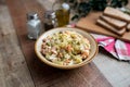 Bowl of traditional Russian salad called Olivie, Russian New Year or Christmas salad on wooden background. Royalty Free Stock Photo