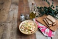 Bowl of traditional Russian salad called Olivie, Russian New Year or Christmas salad on wooden background. Royalty Free Stock Photo