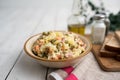 Bowl of traditional Russian salad called Olivie, Russian New Year or Christmas salad on wooden background. Royalty Free Stock Photo