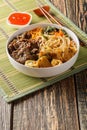 Bowl of traditional Vietnamese noodle salad Bun Bo Nam Bo, with beef, rice noodles, fresh herbs, pickled vegetables and fish sauce Royalty Free Stock Photo