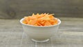 Bowl with triangle slices carrots on wooden rustic