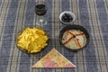 Bowl of tuna salad, tortilla chips, olives and glass of red wine Royalty Free Stock Photo