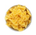 Bowl with uncooked farfalle pasta on white background