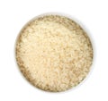 Bowl with uncooked parboiled rice on white, top view