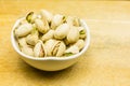 Bowl with unshelled, roasted pistachios.