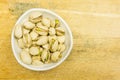 Bowl with unshelled, roasted pistachios. View from above.