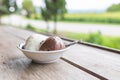 Bowl of various colorful ice cream balls on wooden background