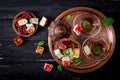 Bowl with various pieces of turkish delight lokum and black tea with mint Royalty Free Stock Photo