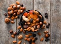 Bowl with various tasty nuts and dried fruits on wooden table