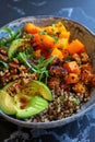 Bowl of vegan salad with quinoa, tofu, avocado, and mixed greens Royalty Free Stock Photo