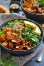 Bowl of vegan salad with quinoa, tofu, avocado, and mixed greens Royalty Free Stock Photo