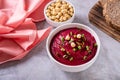 Bowl of vegetable beetroot hummus with chickpeas and herbs on the table Royalty Free Stock Photo