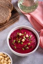 Bowl of vegetable beetroot hummus with chickpeas and herbs on the table vertical view Royalty Free Stock Photo