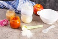 Bowl with vegetables puree and bottle of baby food on gray background Royalty Free Stock Photo