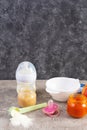 Bowl with vegetables puree and bottle of baby food on gray background Royalty Free Stock Photo