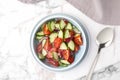 Bowl of vegetarian salad with cucumber, tomato and onion served on table Royalty Free Stock Photo