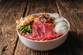 Bowl of vietnamese pho rice noodle with sliced fresh beef and stewed beef