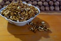 A bowl with walnut kernels and a lot of walnuts folded in the form of a prism Royalty Free Stock Photo
