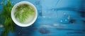 Bowl of water with dill on blue table, serveware containing plant