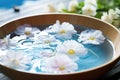 bowl of water with floating flowers for hydropathic therapy Royalty Free Stock Photo