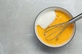 Bowl with whisked eggs and sugar on grey table, top view. Space for text Royalty Free Stock Photo