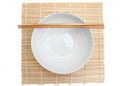 Bowl white empty and chopstick on mat