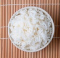 bowl of white steamed rice on bamboo mat. Royalty Free Stock Photo