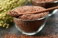 Bowl of whole flax seeds. Glass cup of linseeds, bundle of flax plants