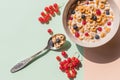 Bowl of whole grain cereal rings with blueberries isolated on pastel background.breakfast of cereal with blueberries,red Royalty Free Stock Photo