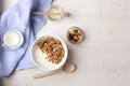 Bowl of whole grain muesli with yogurt on white background, top view Royalty Free Stock Photo