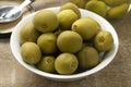 Bowl with whole homemade pickled unripe green almonds