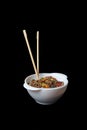 A bowl of wok noodles and chopsticks isolated on black background. Vertical image Royalty Free Stock Photo